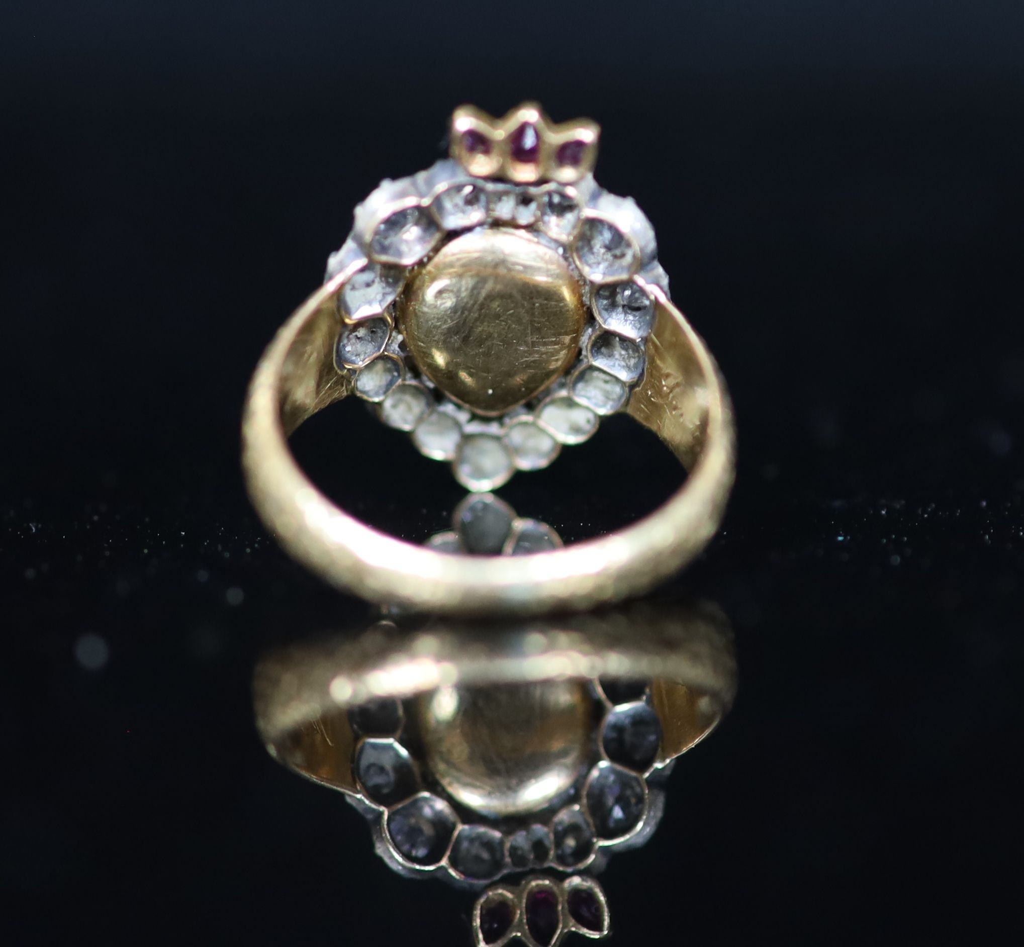 A 19th century gold, pear shaped sapphire, ruby and old cut diamond set flaming heart ring